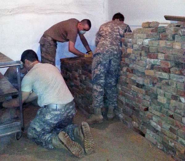 Norwich University cadet volunteers stacking bricks