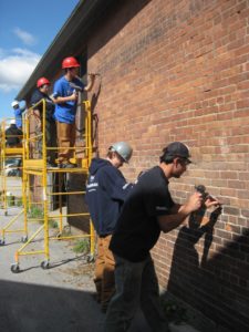 YouthBuild team working on the Bakery brickwork