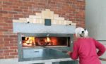 Carolyn Shapiro stoking the wood-fired oven in the Bakery