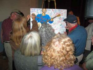 Audience signing Pete Seeger's 90th birthday card 2009