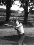 Tom as a young boy, swinging baseball bat